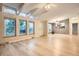 Bright, open living room with wood floors, large windows, and vaulted ceilings at 1062 Pinon Ln, Elizabeth, CO 80107