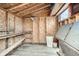 Interior of a shed with plywood walls, overhead storage, and a small window at 1062 Pinon Ln, Elizabeth, CO 80107