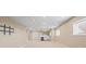 Unfinished basement area with a wet bar, built in shelves, and large window at 23580 E Portland Way, Aurora, CO 80016