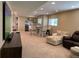 Finished basement with a seating area, entertainment center, table and chairs, and a wet bar at 23580 E Portland Way, Aurora, CO 80016