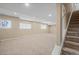 Spacious basement featuring neutral carpet, bright lighting, and ample room for various activities and customization at 23580 E Portland Way, Aurora, CO 80016