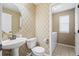 Powder bathroom with decorative wallpaper and tiled floors at 23580 E Portland Way, Aurora, CO 80016