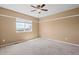 Comfortable carpeted bedroom with a window, offering a bright and serene space for relaxation and rest at 23580 E Portland Way, Aurora, CO 80016