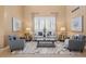 Bright living room featuring neutral tones, stylish decor, a large window, and comfortable seating at 23580 E Portland Way, Aurora, CO 80016
