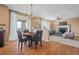 Bright living room featuring hardwood floors, stylish decor, a fireplace, and comfortable seating at 23580 E Portland Way, Aurora, CO 80016