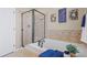 Relaxing bathroom featuring a soaking tub, sleek glass-enclosed shower, and elegant tilework for a spa-like experience at 23580 E Portland Way, Aurora, CO 80016