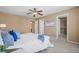 Bright main bedroom featuring soft carpet, ceiling fan, access to ensuite bathroom and a walk-in closet for optimal convenience at 23580 E Portland Way, Aurora, CO 80016