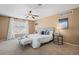 This main bedroom features neutral carpet, ceiling fan, and a large window with blinds at 23580 E Portland Way, Aurora, CO 80016