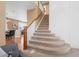 Elegant staircase leading to the upper level with views of the adjacent dining room at 23580 E Portland Way, Aurora, CO 80016