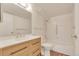 Bright bathroom features a wood vanity, large mirror, and tiled shower with tub at 13992 E Marina Dr # 109, Aurora, CO 80014