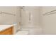Bright bathroom features a shower and tub combo with white tile and grab bar at 13992 E Marina Dr # 109, Aurora, CO 80014