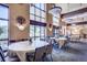 Elegant dining room with large windows, round tables, and stylish decor at 13992 E Marina Dr # 109, Aurora, CO 80014