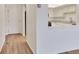 Entryway hall leading to the kitchen, with a pass-through window and stainless steel appliances at 13992 E Marina Dr # 109, Aurora, CO 80014
