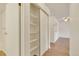Hallway with storage leading to the living area and an open view into the kitchen at 13992 E Marina Dr # 109, Aurora, CO 80014