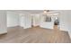 Spacious living room featuring new wood flooring and an open view to the kitchen with stainless appliances at 13992 E Marina Dr # 109, Aurora, CO 80014