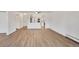 Open living space with wood floors, a ceiling fan, and a view into the updated kitchen at 13992 E Marina Dr # 109, Aurora, CO 80014
