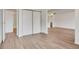 Bright living room features wood-look floors, open layout, closet and access to a full bath and open kitchen at 13992 E Marina Dr # 109, Aurora, CO 80014