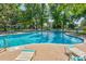 Inviting outdoor pool with ample deck space, lounge chairs and a view of mature trees at 13992 E Marina Dr # 109, Aurora, CO 80014