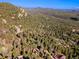 Scenic aerial perspective showcases the property's secluded woodland setting at 31084 Kings Valley Dr, Conifer, CO 80433
