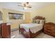 Comfortable bedroom featuring a classic wooden bed frame, dresser, and natural lighting at 31084 Kings Valley Dr, Conifer, CO 80433