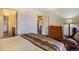 Comfortable bedroom with access to the bathroom, a dresser and a comfortable chair at 31084 Kings Valley Dr, Conifer, CO 80433