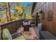 Inviting deck with seating and outdoor decor, surrounded by lush trees at 31084 Kings Valley Dr, Conifer, CO 80433