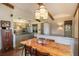 Open dining area featuring exposed wood beams, stylish light fixture, and seamless kitchen access at 31084 Kings Valley Dr, Conifer, CO 80433