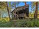 A unique two-story cabin with multi-level decks surrounded by a lush forest at 31084 Kings Valley Dr, Conifer, CO 80433