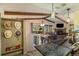 Inviting interior view showcasing an open floor plan, stone fireplace, and wood beam accents at 31084 Kings Valley Dr, Conifer, CO 80433