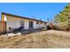 Backyard with grass, trees, a patio, and a house with white siding at 436 Pluto Ct, Lone Tree, CO 80124