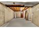Unfinished basement with exposed beams, concrete wall, and carpeted floor at 436 Pluto Ct, Lone Tree, CO 80124