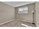 Simple carpeted bedroom with a window featuring ample natural light and a neutral color scheme at 436 Pluto Ct, Lone Tree, CO 80124