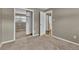 Comfortable bedroom with neutral-colored walls, plush carpeting, and a mirrored closet, providing a serene retreat at 436 Pluto Ct, Lone Tree, CO 80124