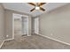 Bedroom features a ceiling fan, mirrored closet, and neutral color scheme at 436 Pluto Ct, Lone Tree, CO 80124