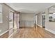 Inviting entryway boasting gleaming hardwood floors, a decorative railing, and an open doorway to the kitchen, offering a warm welcome at 436 Pluto Ct, Lone Tree, CO 80124