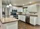 Well-lit kitchen features stainless steel appliances, updated cabinets and plenty of counter space at 436 Pluto Ct, Lone Tree, CO 80124