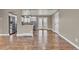 Spacious living area featuring hardwood floors, neutral paint colors, and abundant natural light, with seamless transition to the kitchen at 436 Pluto Ct, Lone Tree, CO 80124