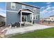 Relax on the concrete patio with stylish outdoor seating in this charming home's backyard at 2186 Prairie Smoke Dr, Monument, CO 80132