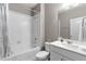 Bright bathroom with a combination tub and shower, a white vanity, and modern fixtures at 2186 Prairie Smoke Dr, Monument, CO 80132