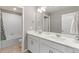 Bathroom featuring a double vanity, white cabinets, solid surface counters, tub and shower combo, and neutral walls at 2186 Prairie Smoke Dr, Monument, CO 80132