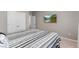 Cozy bedroom with neutral walls and carpeted floors features a TV and access to a hallway at 2186 Prairie Smoke Dr, Monument, CO 80132