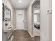 Bright entryway with a mirror and console table, hardwood floors, and a view into a bedroom at 2186 Prairie Smoke Dr, Monument, CO 80132