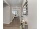 Welcoming entryway with hardwood floors, a stylish mirror, and a view into the living and dining areas at 2186 Prairie Smoke Dr, Monument, CO 80132