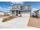 Charming two-story home featuring a covered porch, attached two car garage and mature landscaping at 2186 Prairie Smoke Dr, Monument, CO 80132
