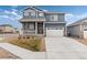 Charming two-story home featuring a covered porch, attached two car garage and mature landscaping at 2186 Prairie Smoke Dr, Monument, CO 80132