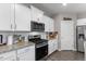 Well-lit kitchen featuring granite countertops, stainless steel appliances, and white cabinets at 2186 Prairie Smoke Dr, Monument, CO 80132