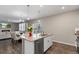 Open kitchen and dining area with stainless appliances, white cabinetry, and hardwood flooring at 2186 Prairie Smoke Dr, Monument, CO 80132
