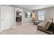 Carpeted loft area featuring a comfortable sofa, tv, and reading lamp at 2186 Prairie Smoke Dr, Monument, CO 80132