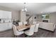 Open concept dining and living room with a fireplace, hardwood floors, and modern furnishings at 2186 Prairie Smoke Dr, Monument, CO 80132