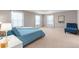 Spacious main bedroom with lots of natural light, plush carpeting, and a cozy seating area at 2186 Prairie Smoke Dr, Monument, CO 80132